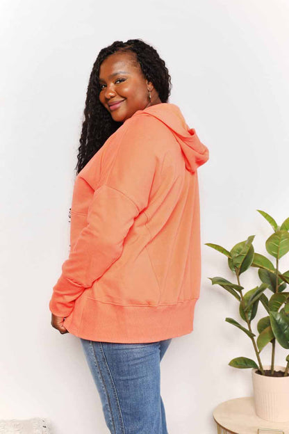 Tangerine Trendsi Double Take Quarter-Snap Dropped Shoulder Hoodie with relaxed fit and dropped sleeves.