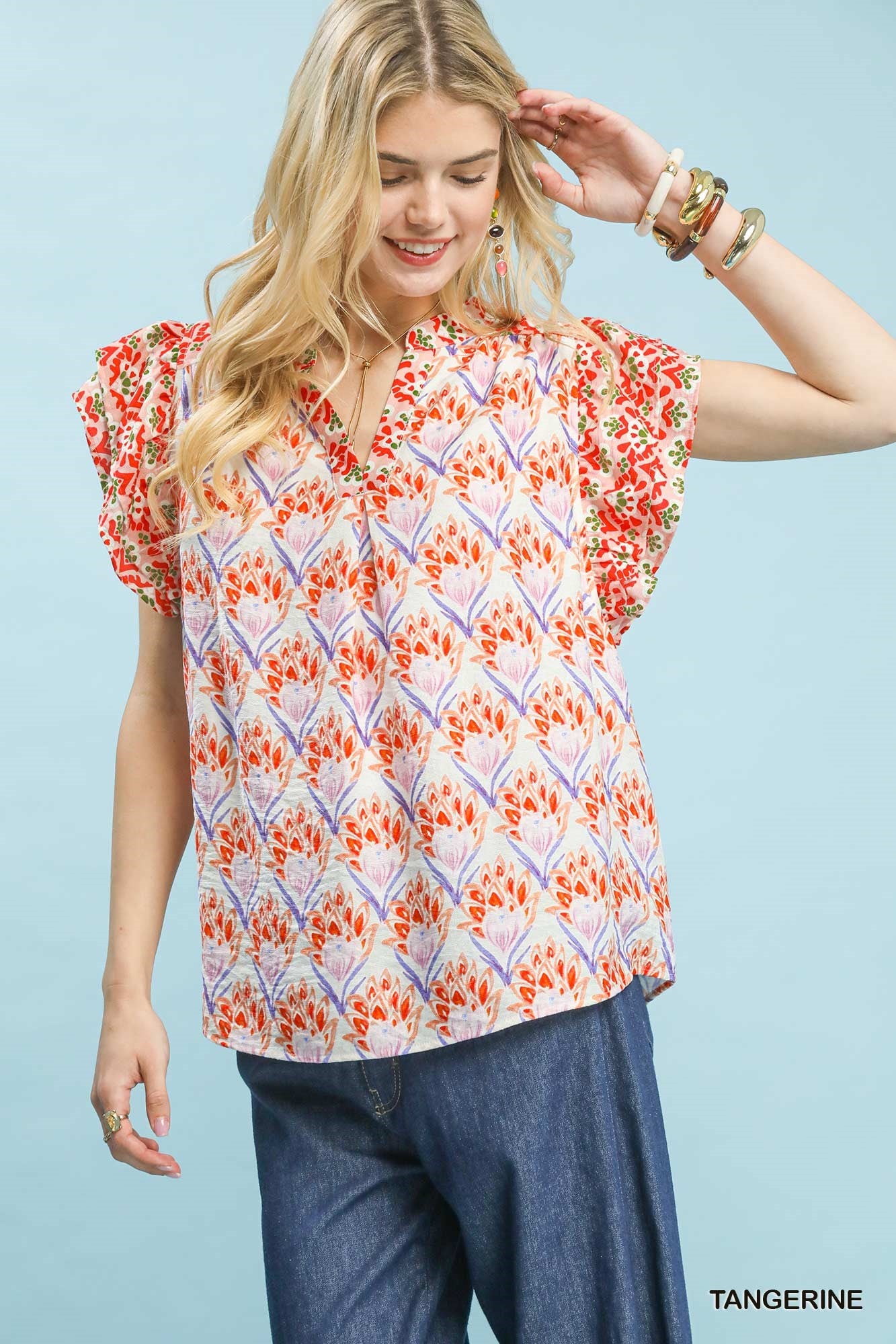 Tangerine floral blouse by Umgee with double frill sleeves, lightweight fabric, and a relaxed fit, perfect for casual wear.
