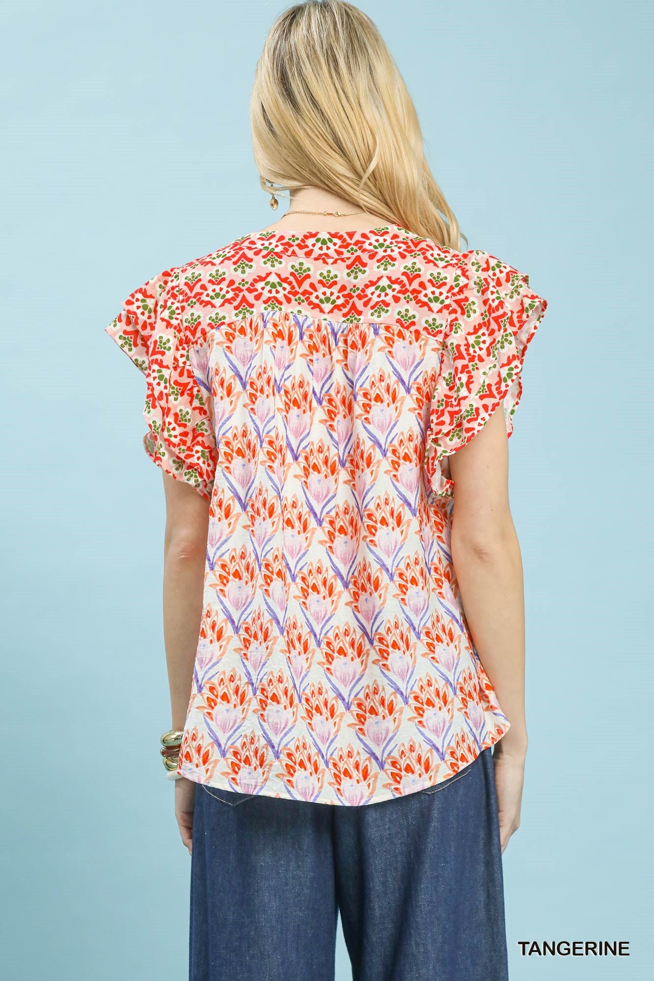 Tangerine floral blouse with double frill sleeves from Umgee, featuring a feminine, lightweight design and vibrant print.
