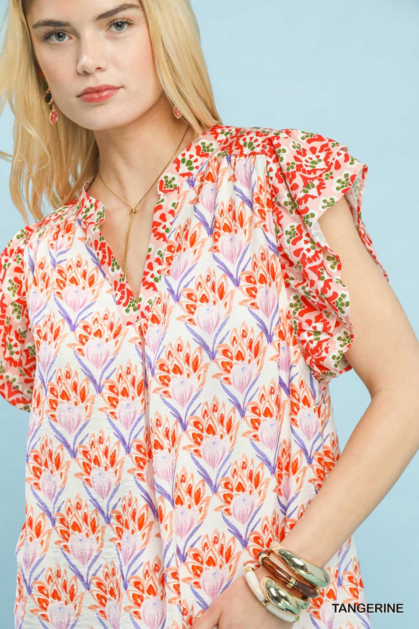 Tangerine floral blouse by Umgee with double frill sleeves, featuring a feminine and flowy design.