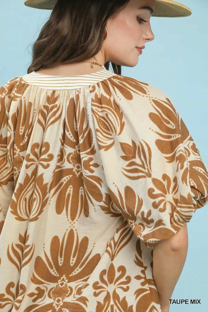 Taupe Umgee printed puff sleeve top with contrast trim, featuring a stylish mix of patterns and lightweight fabric.