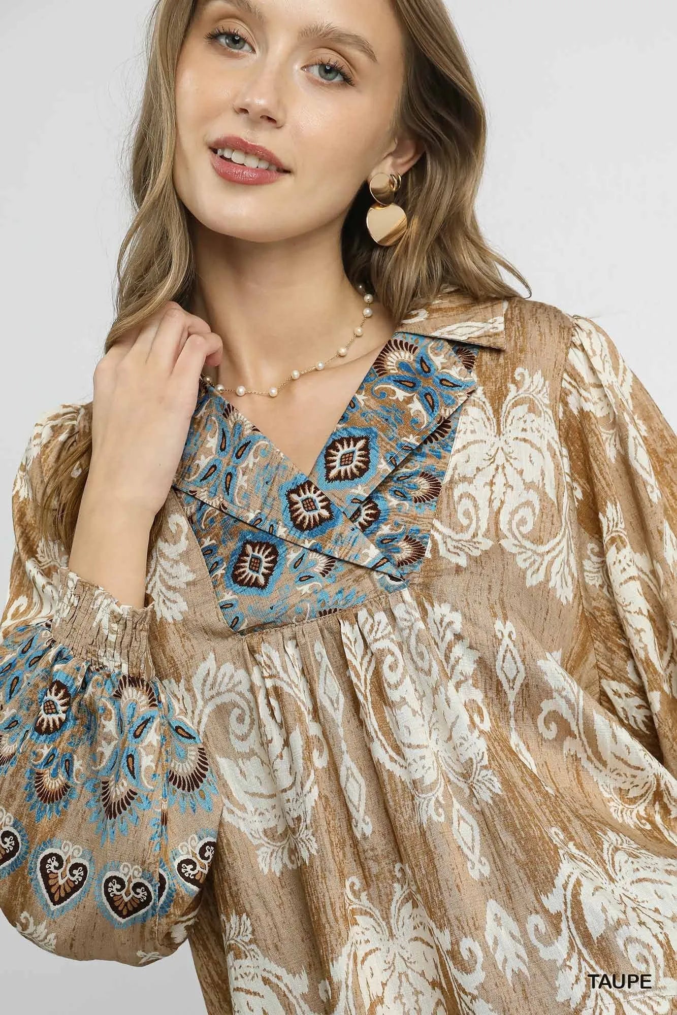 Taupe Umgee floral boho blouse with scalloped hem, featuring a relaxed fit and eye-catching bohemian floral pattern.