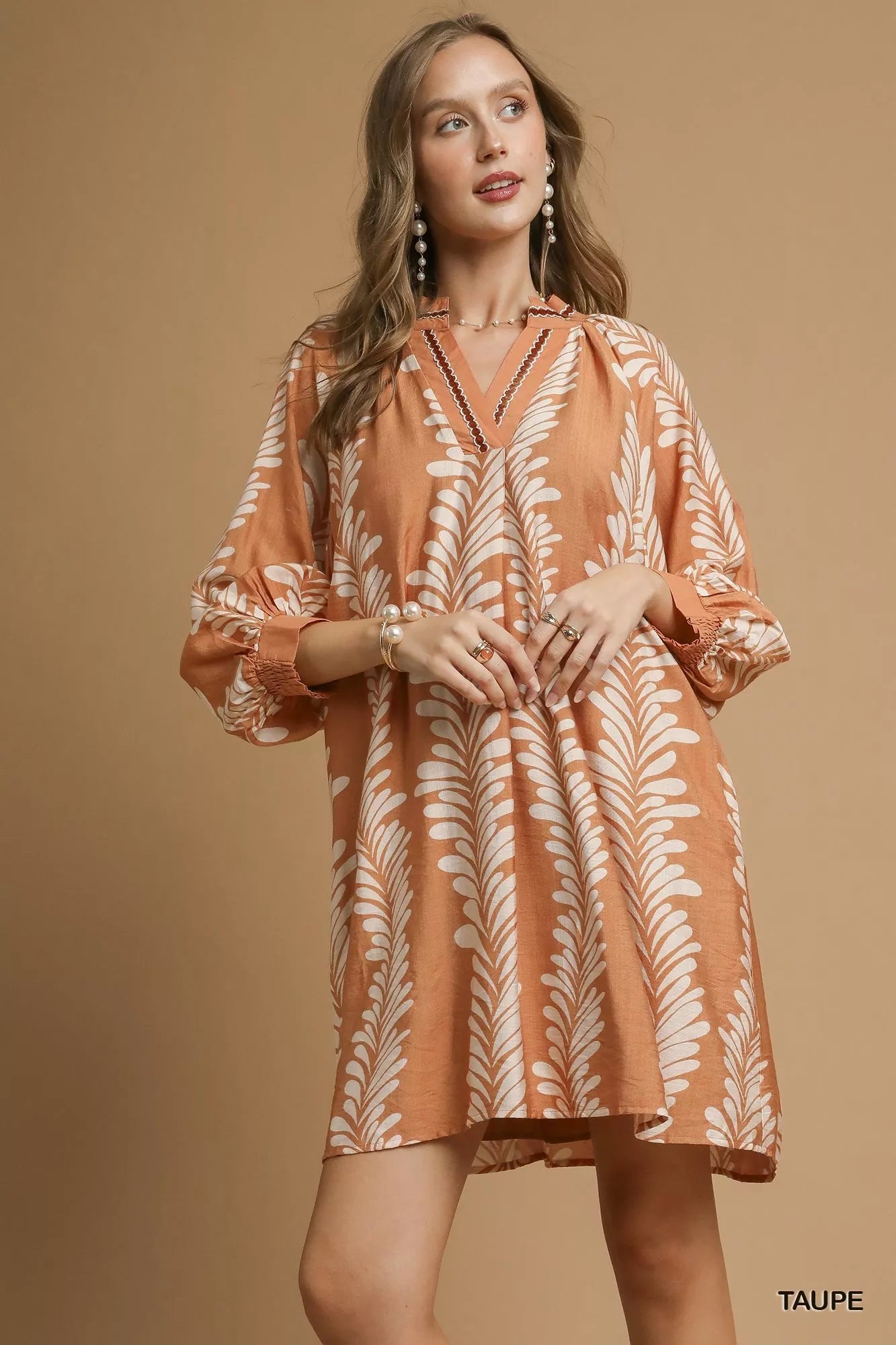 Taupe leaf print Umgee mini babydoll dress with notched neckline, featuring a flowy, lightweight design perfect for casual wear.