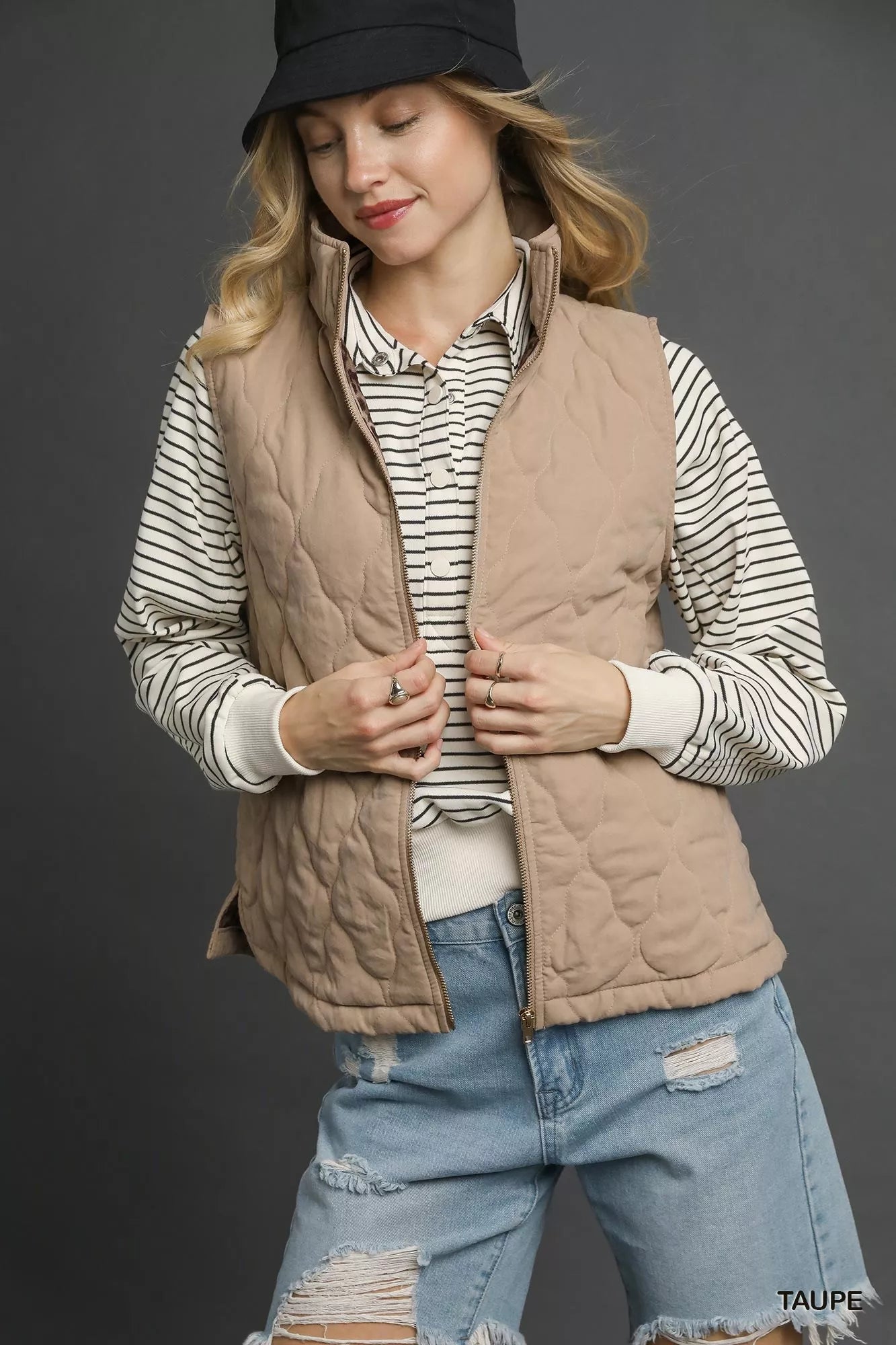 Taupe Umgee quilted zip-up vest with stand collar and front pockets, featuring a stylish and cozy design from Trendsi.