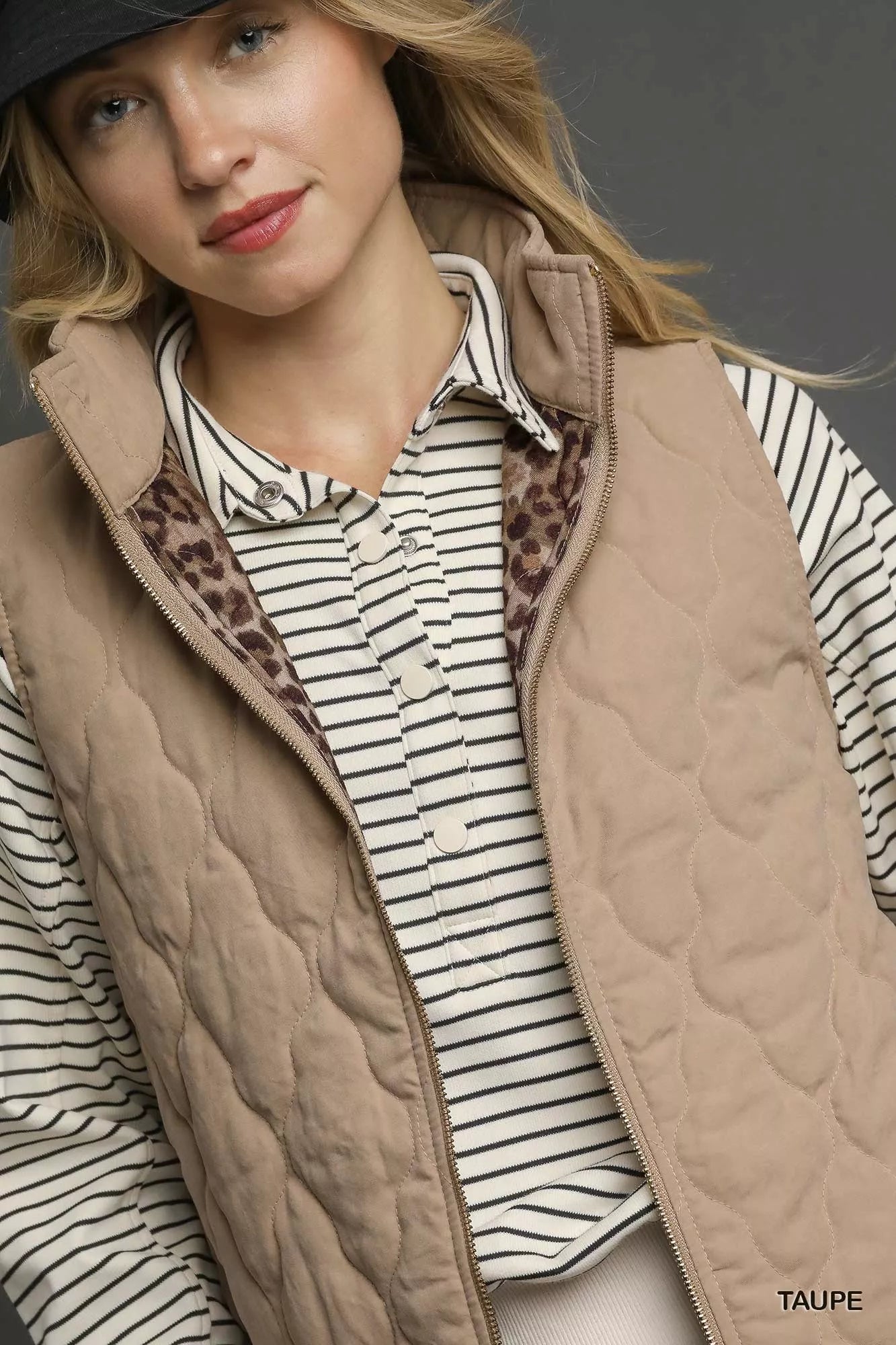 Taupe Umgee quilted zip-up vest from Trendsi, featuring a stand collar and front zipper, ideal for layering and casual wear.