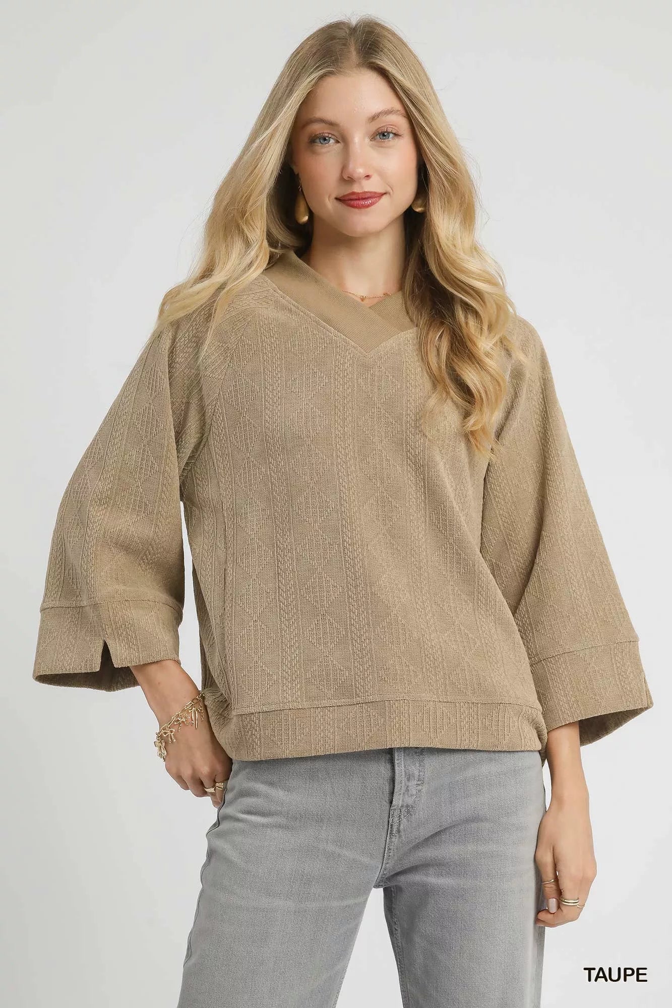 Taupe Umgee textured knit V-neck top by Trendsi, featuring a cozy fit and detailed knit pattern, perfect for casual wear.