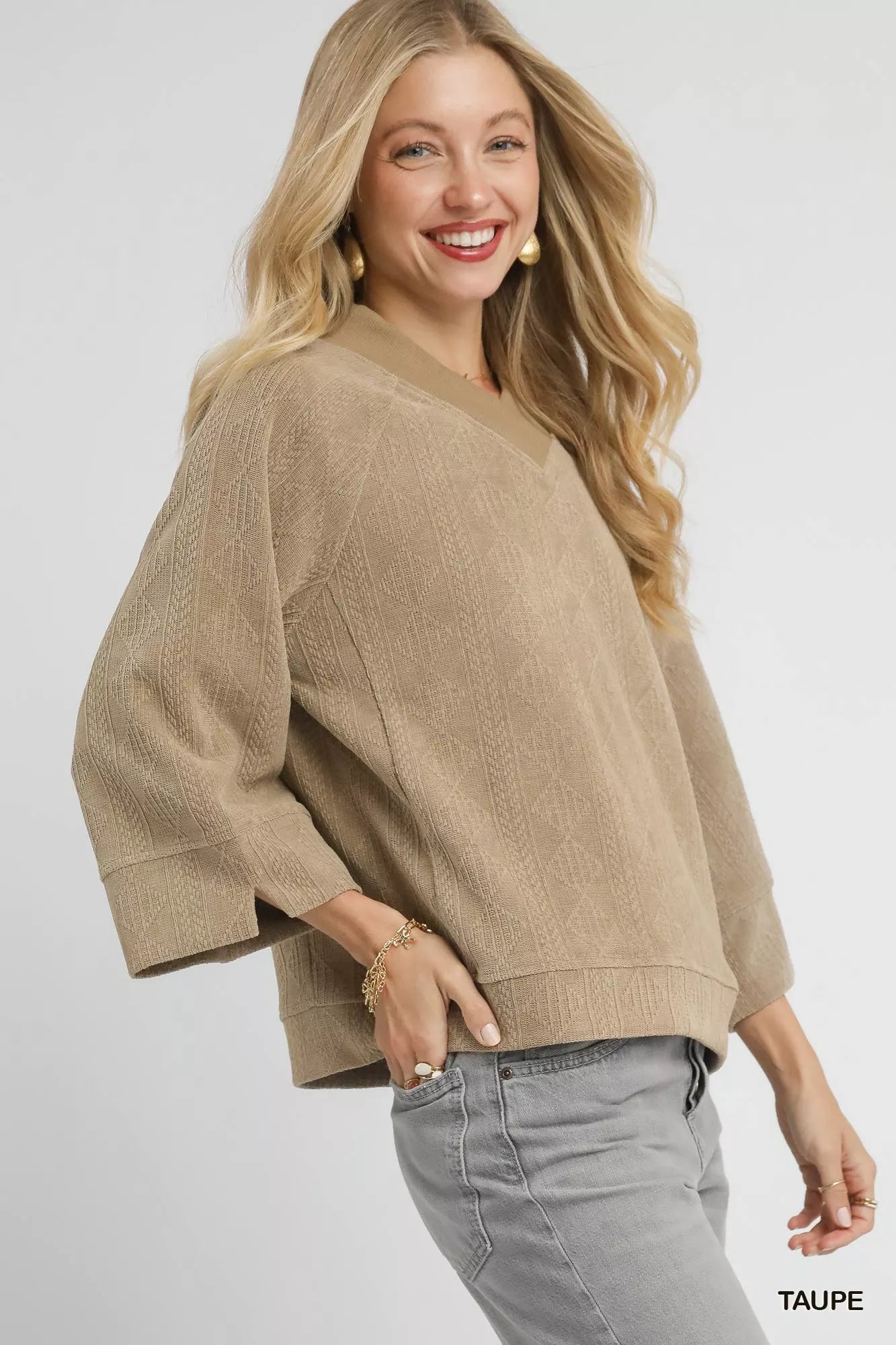 Taupe textured knit V-neck top by Umgee featuring a relaxed fit and long sleeves, styled casually.