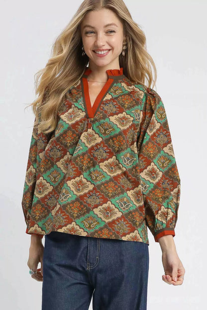Teal and green abstract print ruffle neck top by Umgee, featuring a stylish design and feminine ruffle detail.