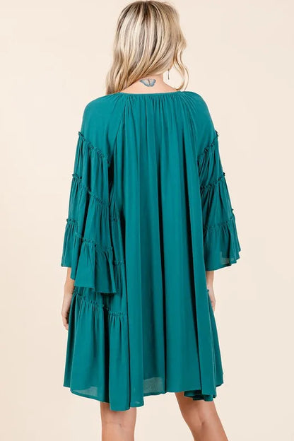 Teal green Mittoshop bell sleeve dress with tie neck and frill detail, featuring a stylish and feminine design.