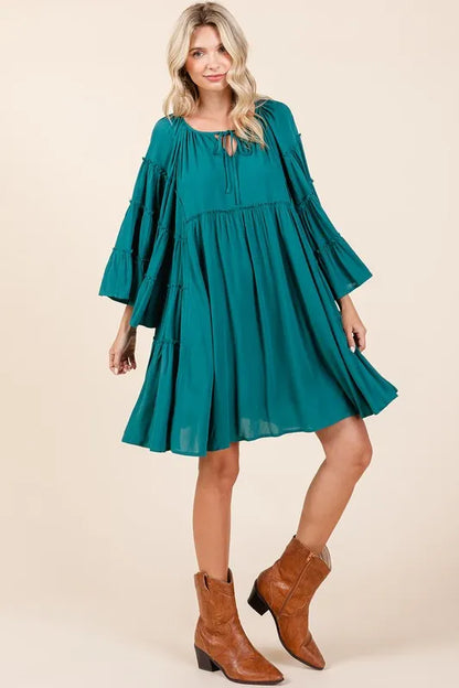 Teal green Mittoshop bell sleeve dress with tie neck and frill accents, featuring a stylish and feminine silhouette.