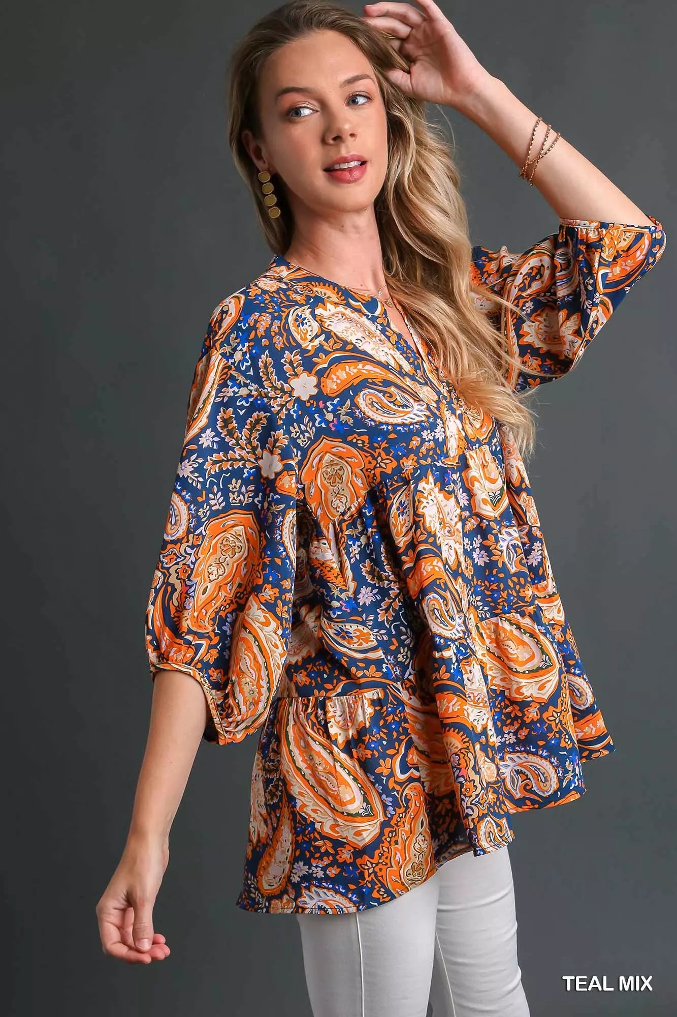 Teal Umgee Mix Paisley Boho Tunic Blouse with long sleeves and relaxed fit, styled on a hanger.