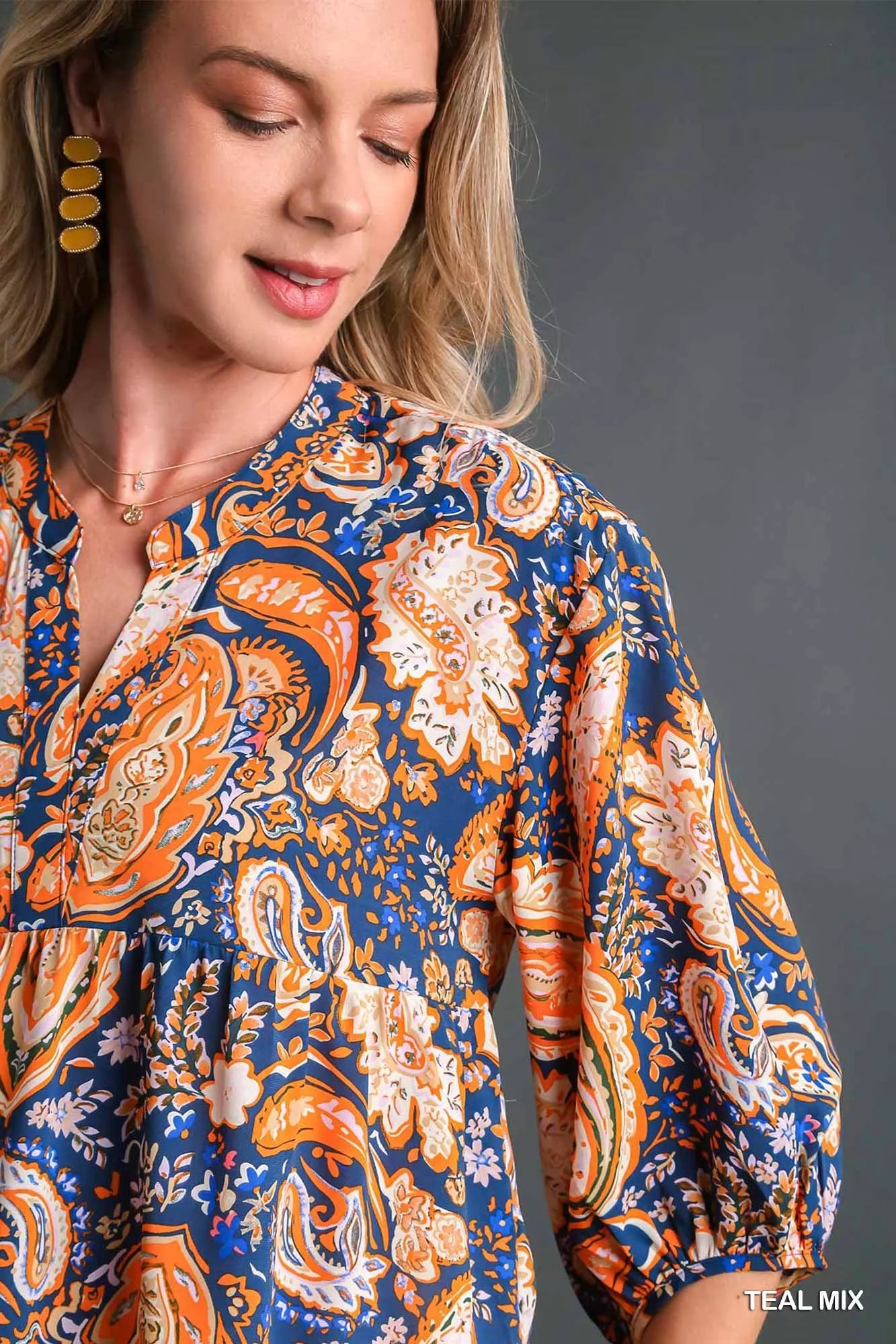 Teal Umgee Mix Paisley Boho Tunic Blouse with flowy fit and long sleeves, styled on a mannequin for a casual bohemian look.