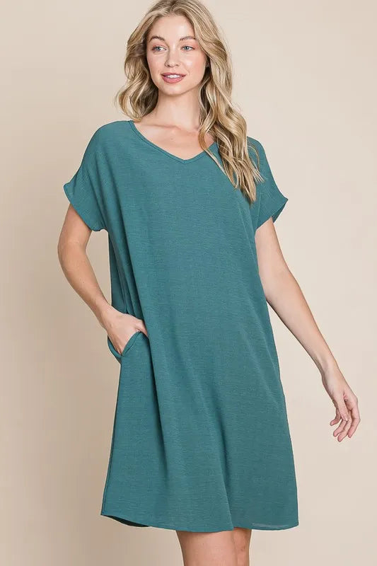 Teal BOMBOM V-Neck short sleeve dress with pockets, casual style, from Trendsi, shown on a mannequin.