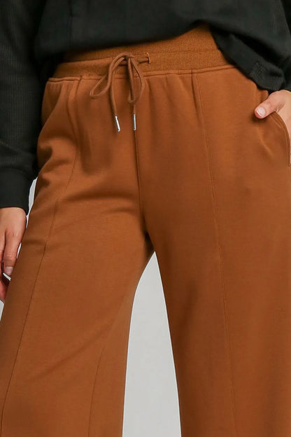 Terracotta Umgee drawstring wide-leg pants with pockets, casual women's pants from Trendsi, shown on a model.