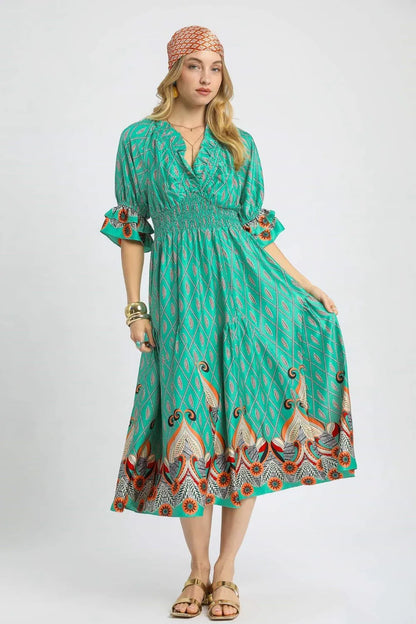 Turquoise Umgee printed midi dress with smocked waist and flounce sleeves, showcasing a stylish boho-inspired design.