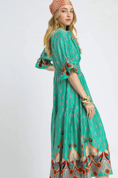 Turquoise Umgee printed midi dress with smocked waist and flounce sleeves, stylish and comfortable for casual or dressy occasions.