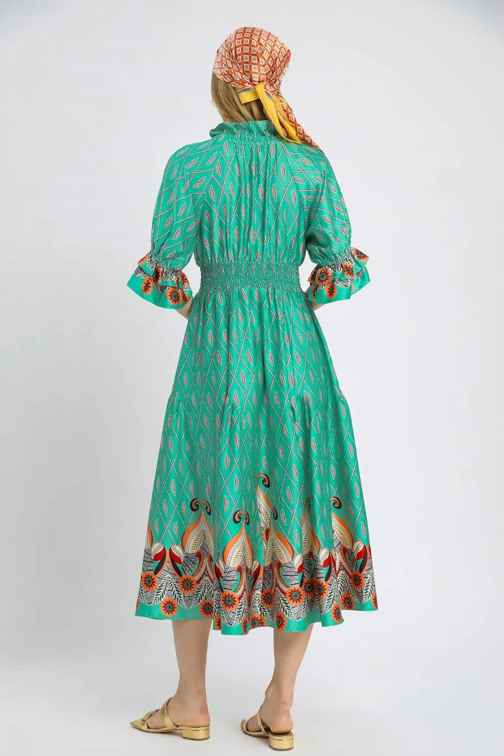Turquoise Umgee printed midi dress with smocked waist and flounce sleeves, stylish and flowy for casual or dressy occasions.