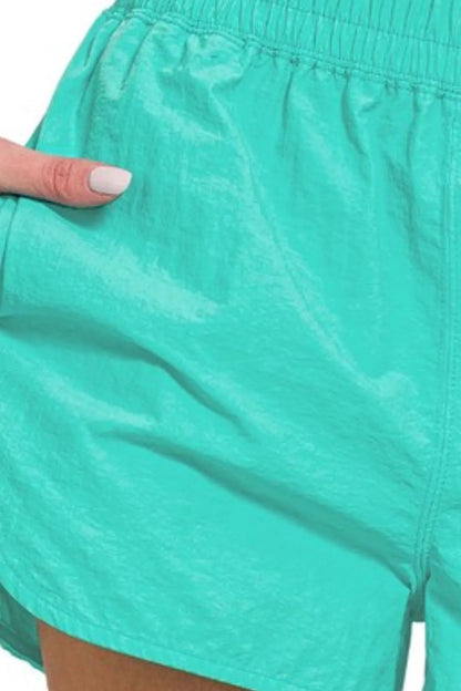 Turquoise Zenana windbreaker running shorts with smocked waistband and relaxed fit, ideal for active wear.