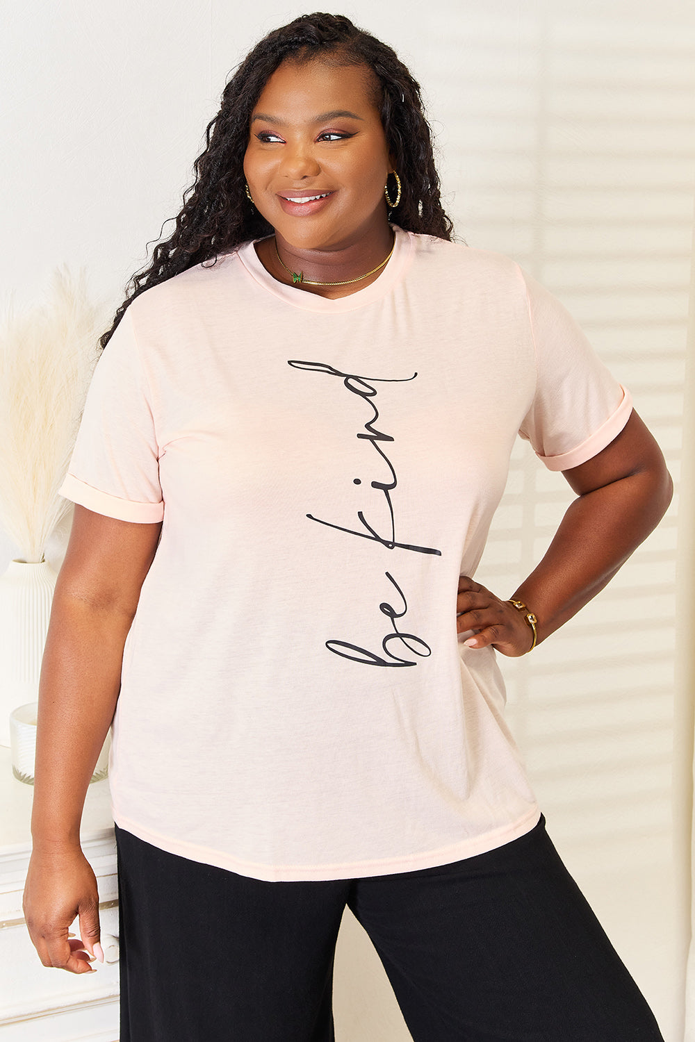 Pink Simply Love BE KIND graphic round neck T-shirt by Trendsi, featuring a colorful "Be Kind" message and casual fit.