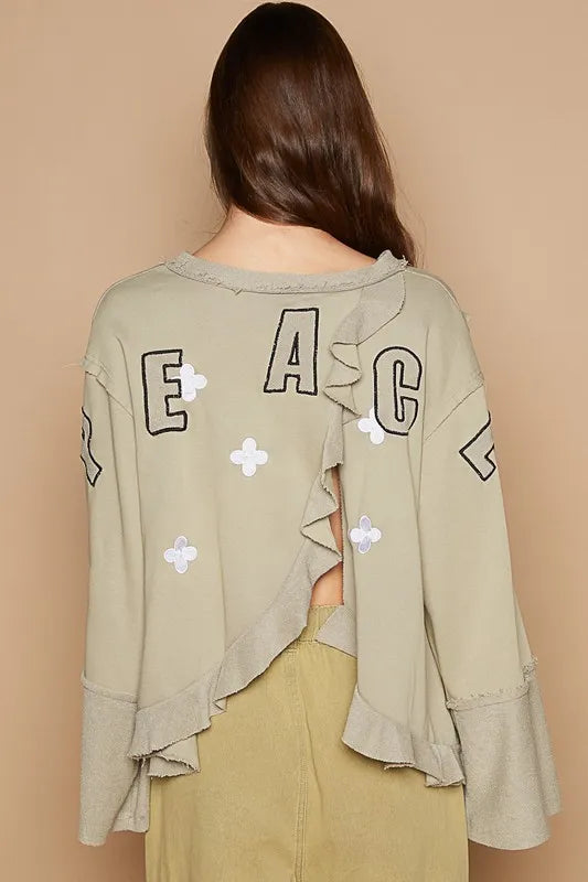Wheat grass POL Peace embroidered V-neck top with exposed seam back and ruffle details, by Trendsi.