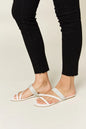 White Wild Diva rhinestone strappy flat sandals with multiple thin straps and flat sole, perfect for casual summer wear.
