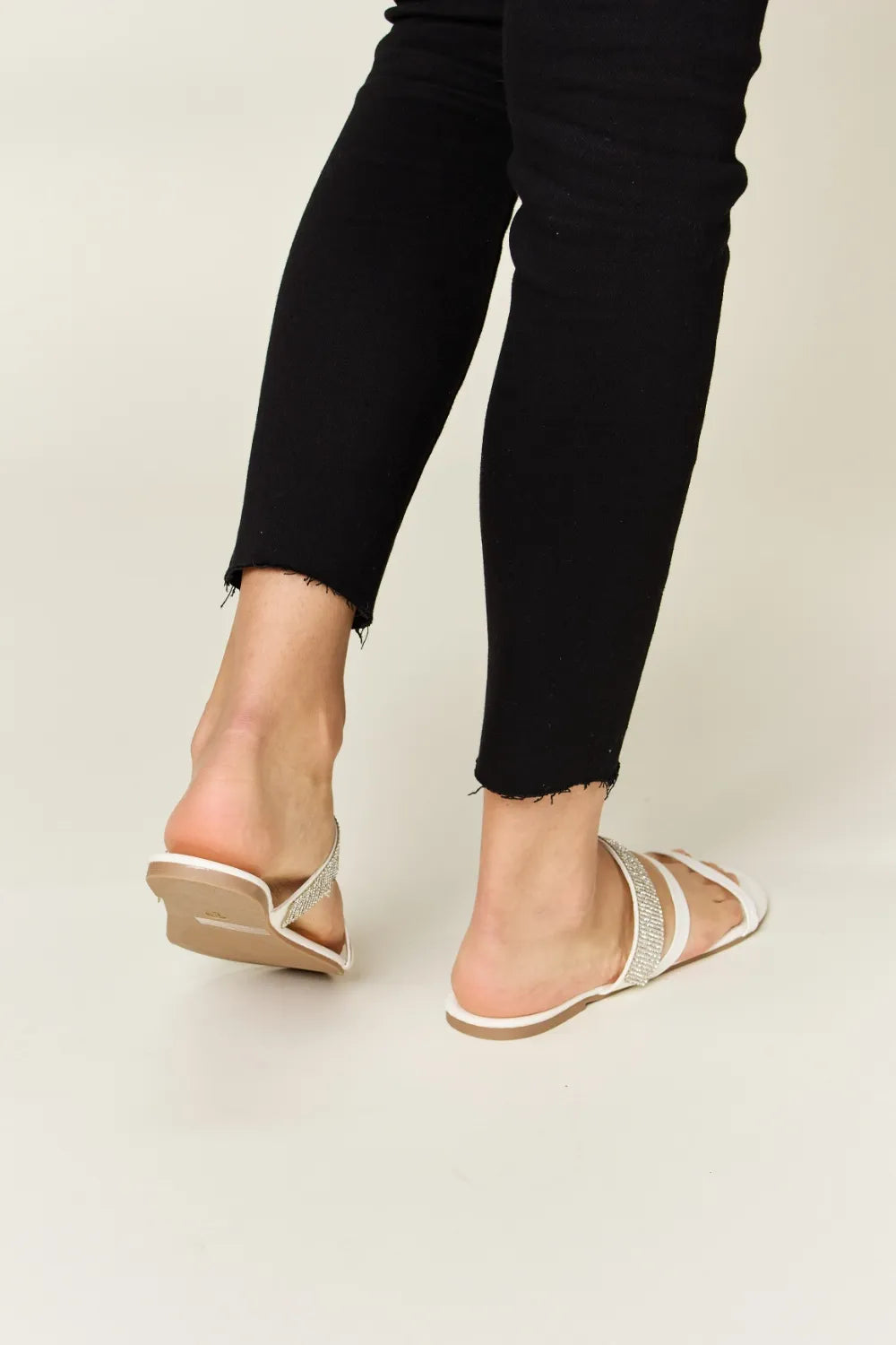 White WILD DIVA Rhinestone Strappy Flat Sandals from Trendsi, featuring sparkling rhinestone straps and a flat sole for casual style.