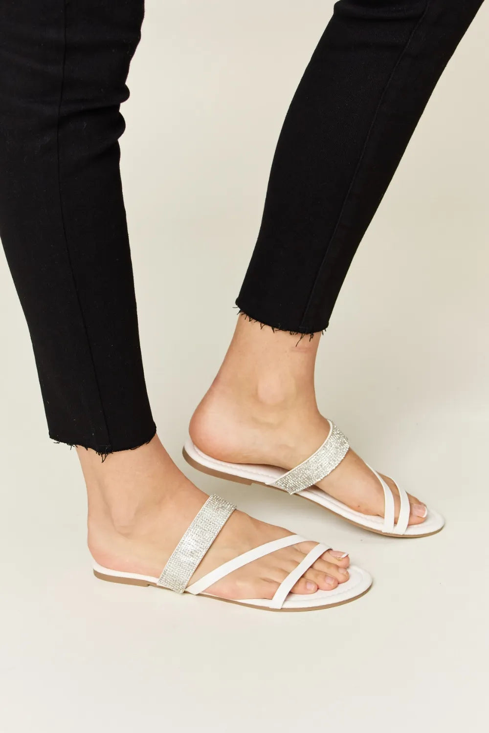 White WILD DIVA Rhinestone Strappy Flat Sandals by Trendsi with sparkling rhinestone details and multiple strap design.
