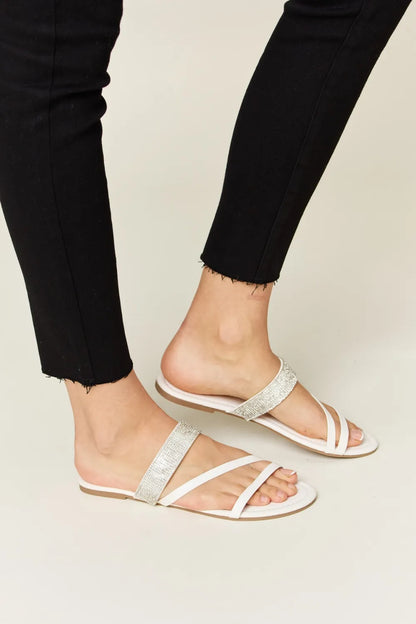 White WILD DIVA Rhinestone Strappy Flat Sandals by Trendsi with sparkling rhinestone details and multiple strap design.