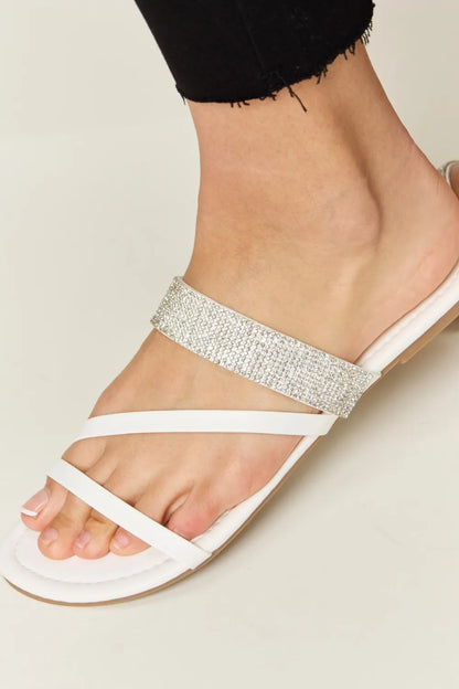 White Wild Diva rhinestone strappy flat sandals with multiple thin straps and flat sole, stylish and comfortable for casual wear.