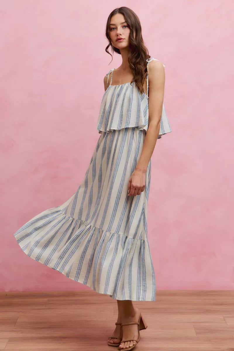 White and blue striped SO ME tiered midi dress with shoulder tie detail, lined, by Trendsi, shown on a model.
