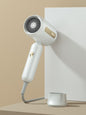 White portable negative ion high-speed hair dryer with European plug from Trendsi, showcasing its compact design and ergonomic handle.