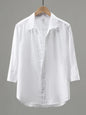Men's plus size white button-up long sleeve shirt by Trendsi, displayed flat showing collar, buttons, and long sleeves.