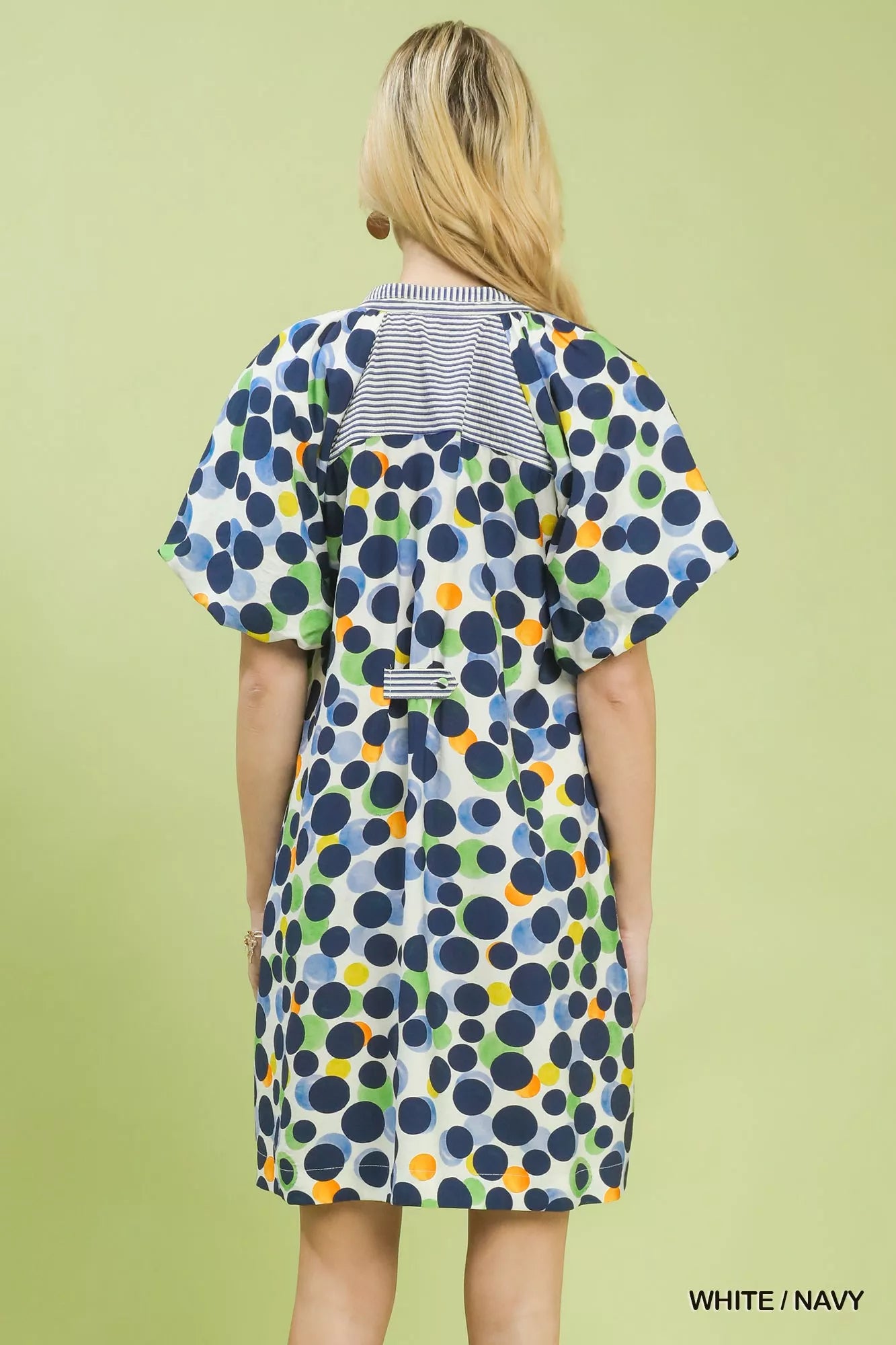 White and navy polka dot print Umgee tunic dress from Trendsi, featuring a relaxed fit and casual style.