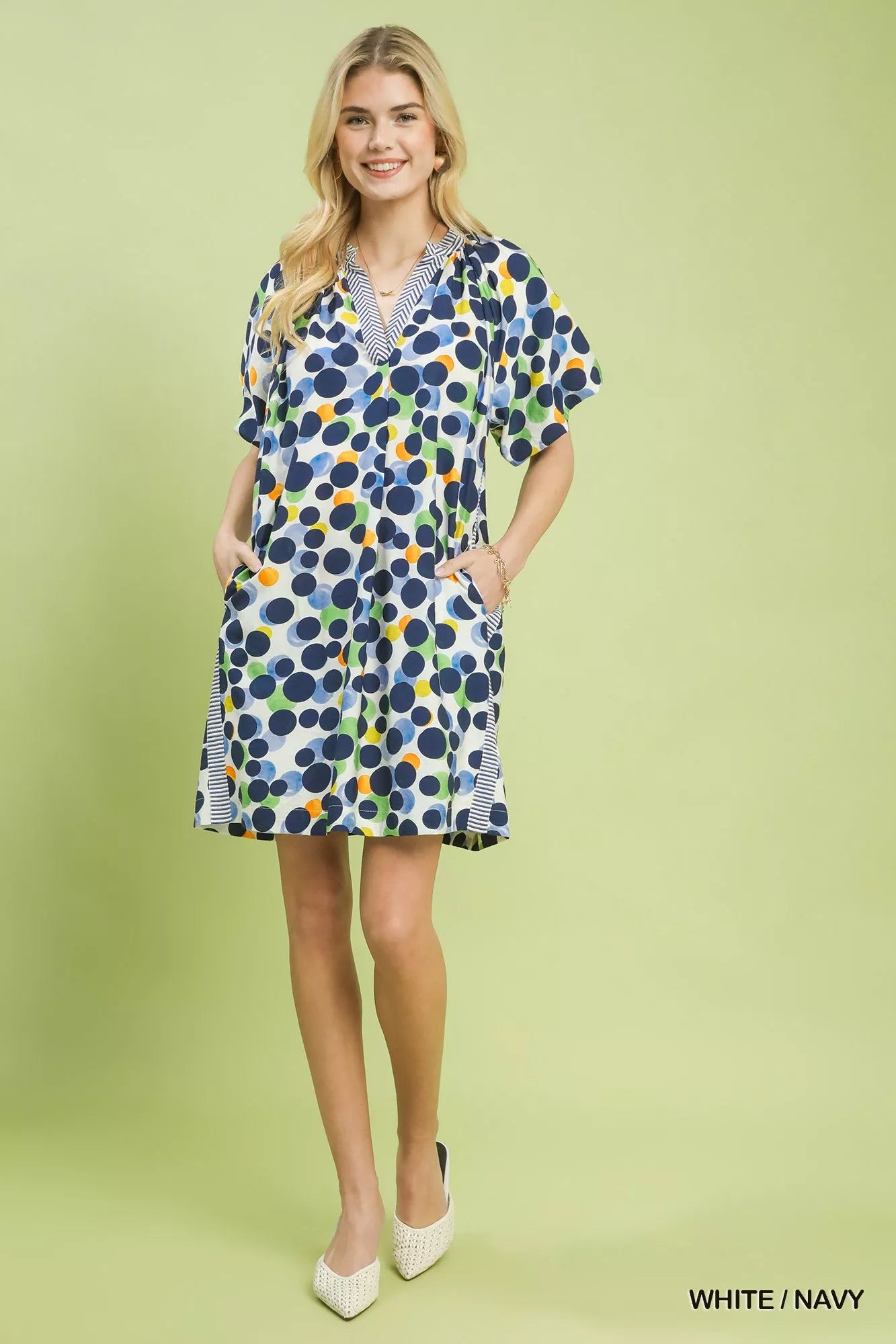 White and navy polka dot print Umgee tunic dress by Trendsi, featuring a relaxed fit and feminine style.