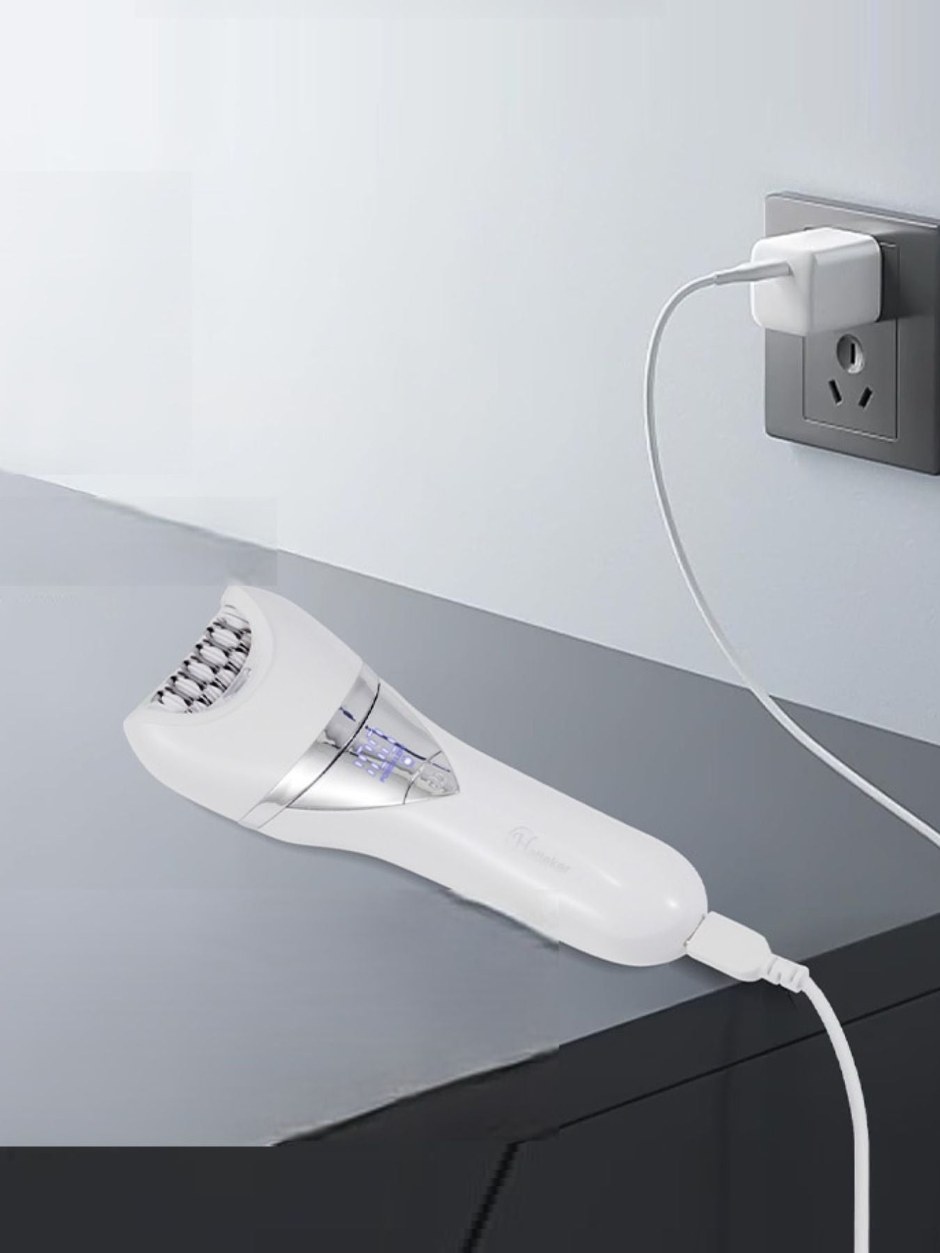 White painless electric hair removal epilator by Trendsi with multiple attachment heads for gentle at-home hair removal.
