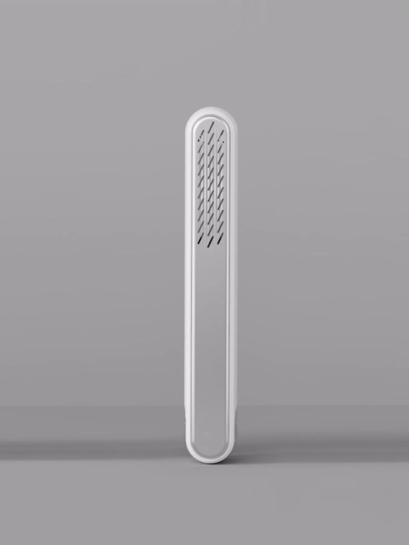 White portable heated straightening comb by Trendsi, featuring a sleek design for easy hair styling on the go.