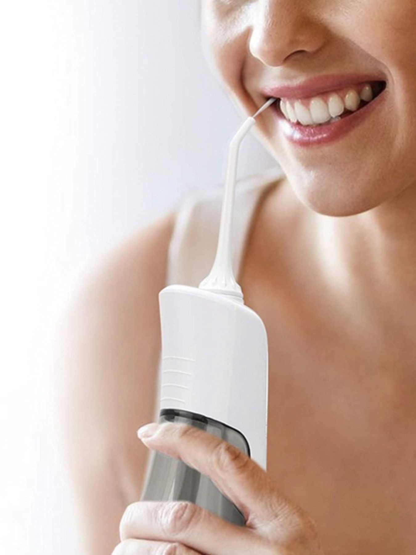 White cordless water power dental flosser for teeth cleaning with a sleek design by Trendsi.