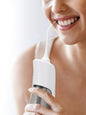 White cordless water power dental flosser for teeth cleaning with a sleek design by Trendsi.
