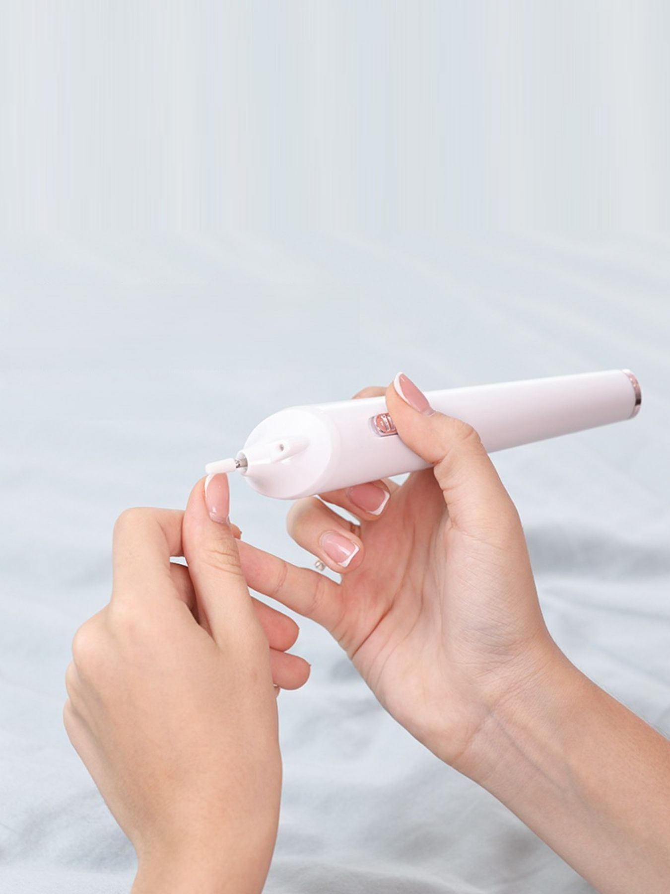 White electric nail buffer from Trendsi with a sleek design, perfect for shaping and polishing nails at home.