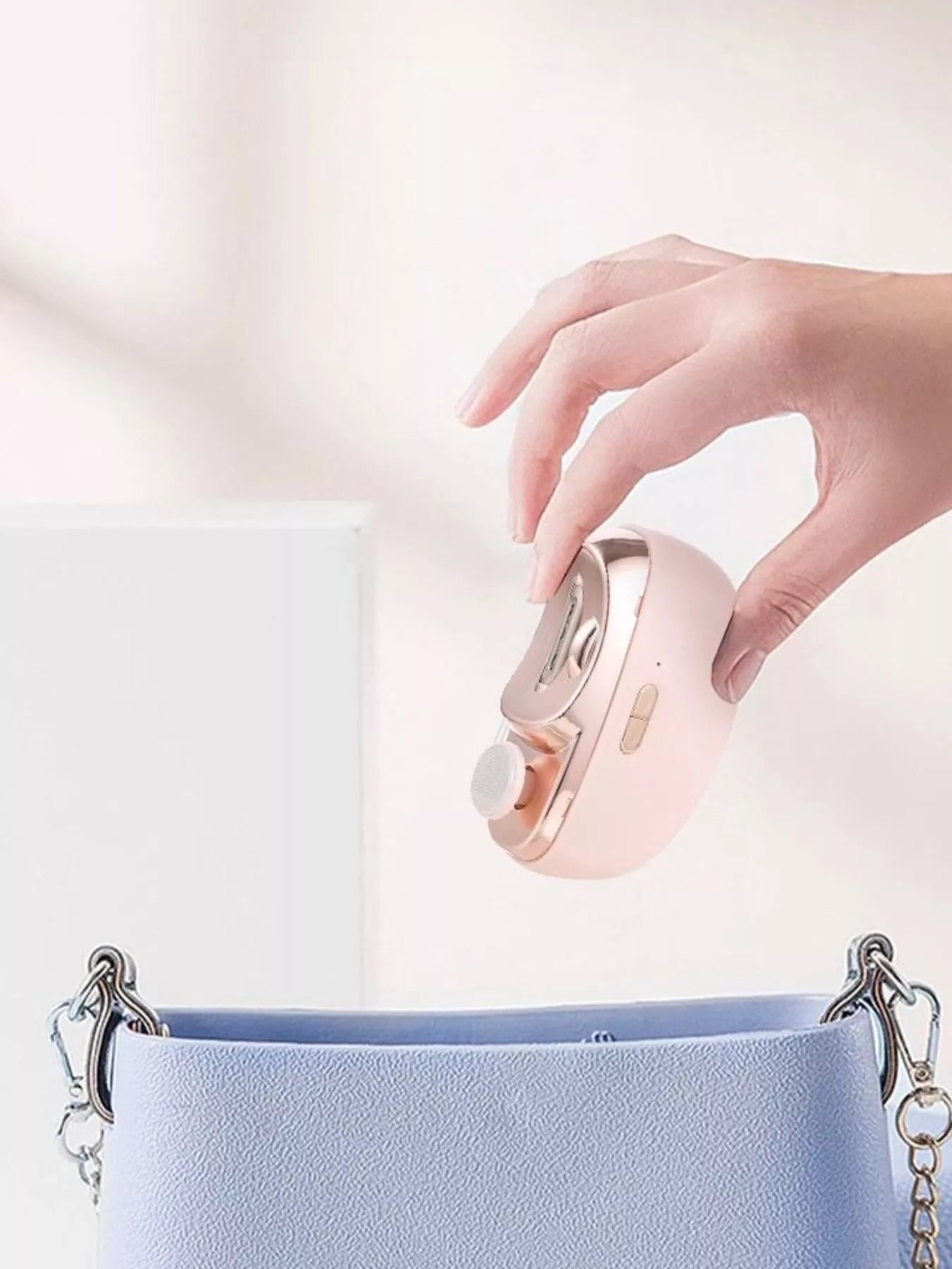 White electric nail buffer by Trendsi with multiple polishing surfaces for smooth, shiny nails.