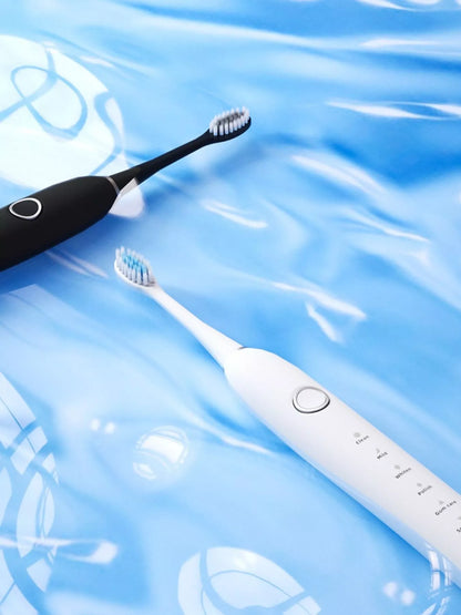 White electric toothbrush with multiple cleaning modes from Trendsi, featuring ergonomic design and replaceable brush head.