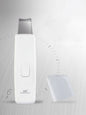 White facial skin scrubber and blackhead extractor from Trendsi, showing the handheld device with textured surface for pore cleansing.