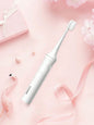 White portable electric toothbrush by Trendsi with a compact design and ergonomic handle for on-the-go oral care.