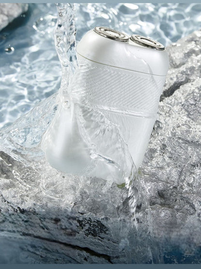 White portable mini electric shaver by Trendsi with compact design and ergonomic handle for easy grooming.