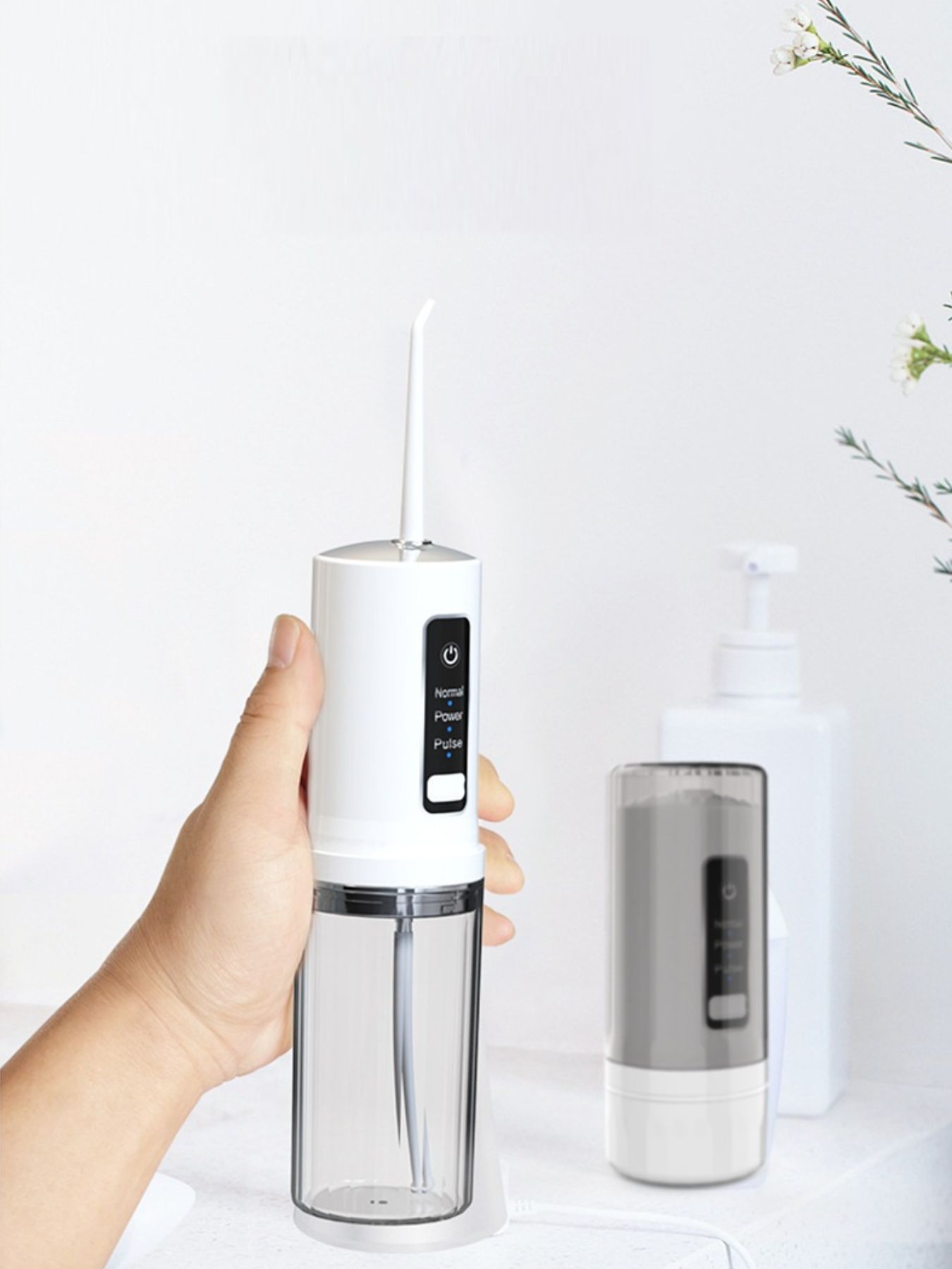 White portable rechargeable power dental flosser from Trendsi with compact design and ergonomic handle for effective oral cleaning.