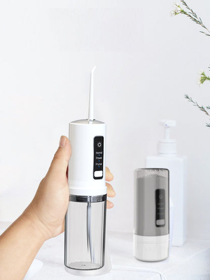 White portable rechargeable power dental flosser from Trendsi with compact design and ergonomic handle for effective oral cleaning.