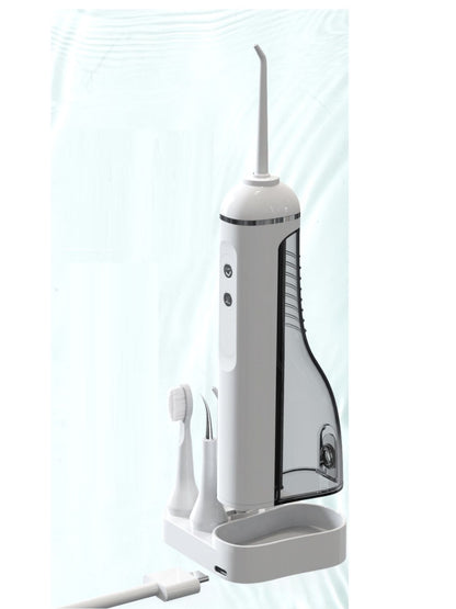 White portable water flosser with multiple nozzles, compact design, and ergonomic handle for oral hygiene.