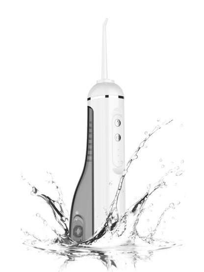 White portable water flosser with multiple nozzles, compact design, ideal for oral hygiene on the go.