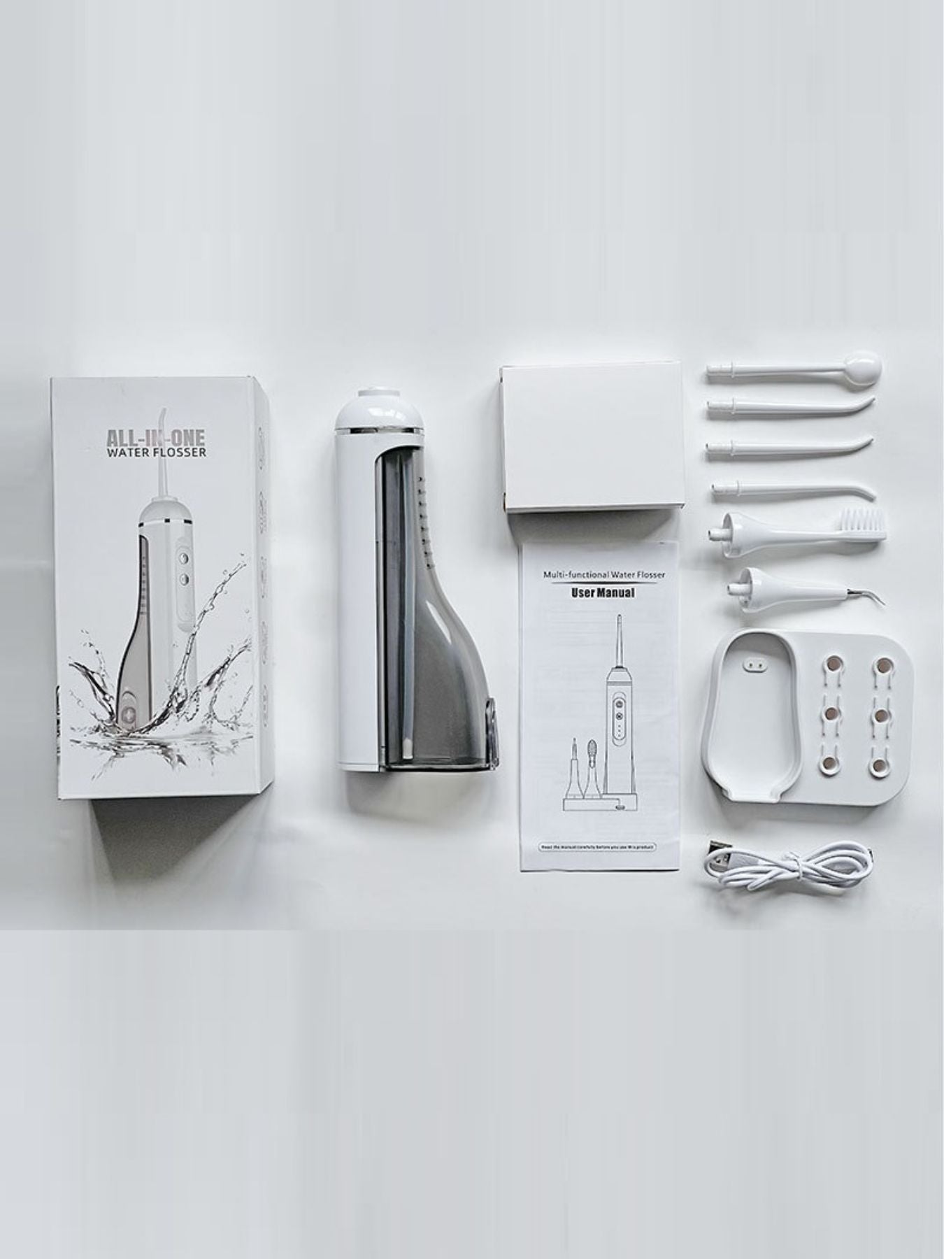 White portable water flosser with multiple nozzles from Trendsi, compact oral hygiene device for effective flossing.