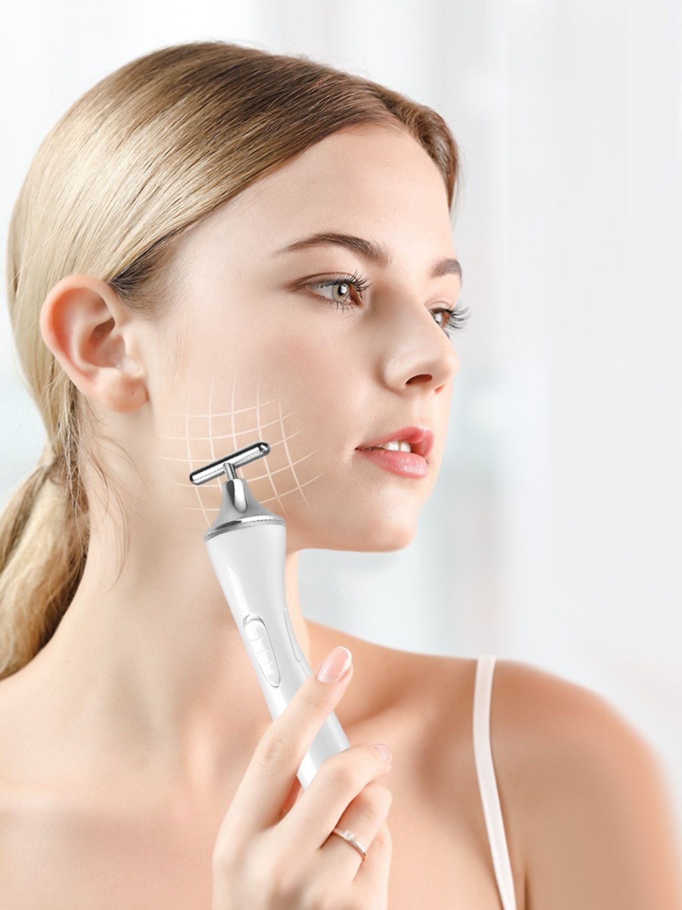 White T-shape microcurrent facial massager by Trendsi, a handheld beauty device for skin rejuvenation and facial toning.